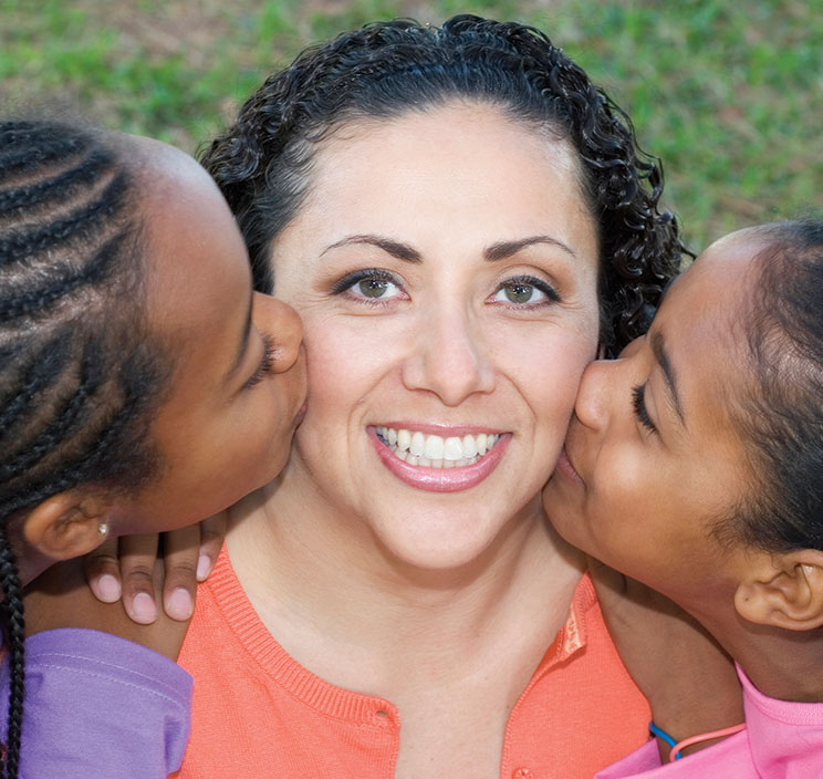 Two girls kissing the cheek of a woman. Links to Gifts of Appreciated Securities Two girls kissing the cheek of a woman. Links to Gifts of Appreciated Securities