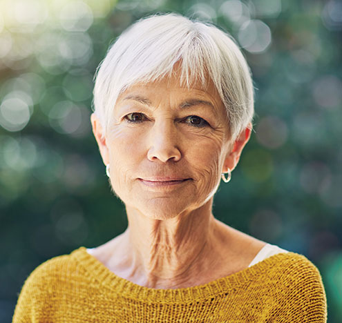 A woman smiling. Links to Gifts of Cash, Checks, and Credit Cards